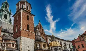 Wawel w Krakowie, idealne miejsce na darmowe wydarzenia. Zobacz majestatyczne wieże i złote kopuły na tle błękitnego nieba.